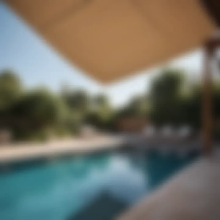 Contemporary sail shade design over a pool for sun protection